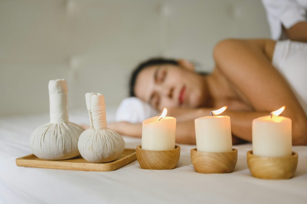 Pregnant women are enjoying a relaxing massage in bed at spa by massage and aromatherapy.